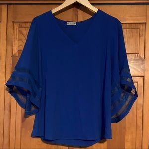 Bright blue, flowing top